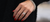 A brilliant diamond ring and diamond bracelet set on the left hand of a woman with red nails.