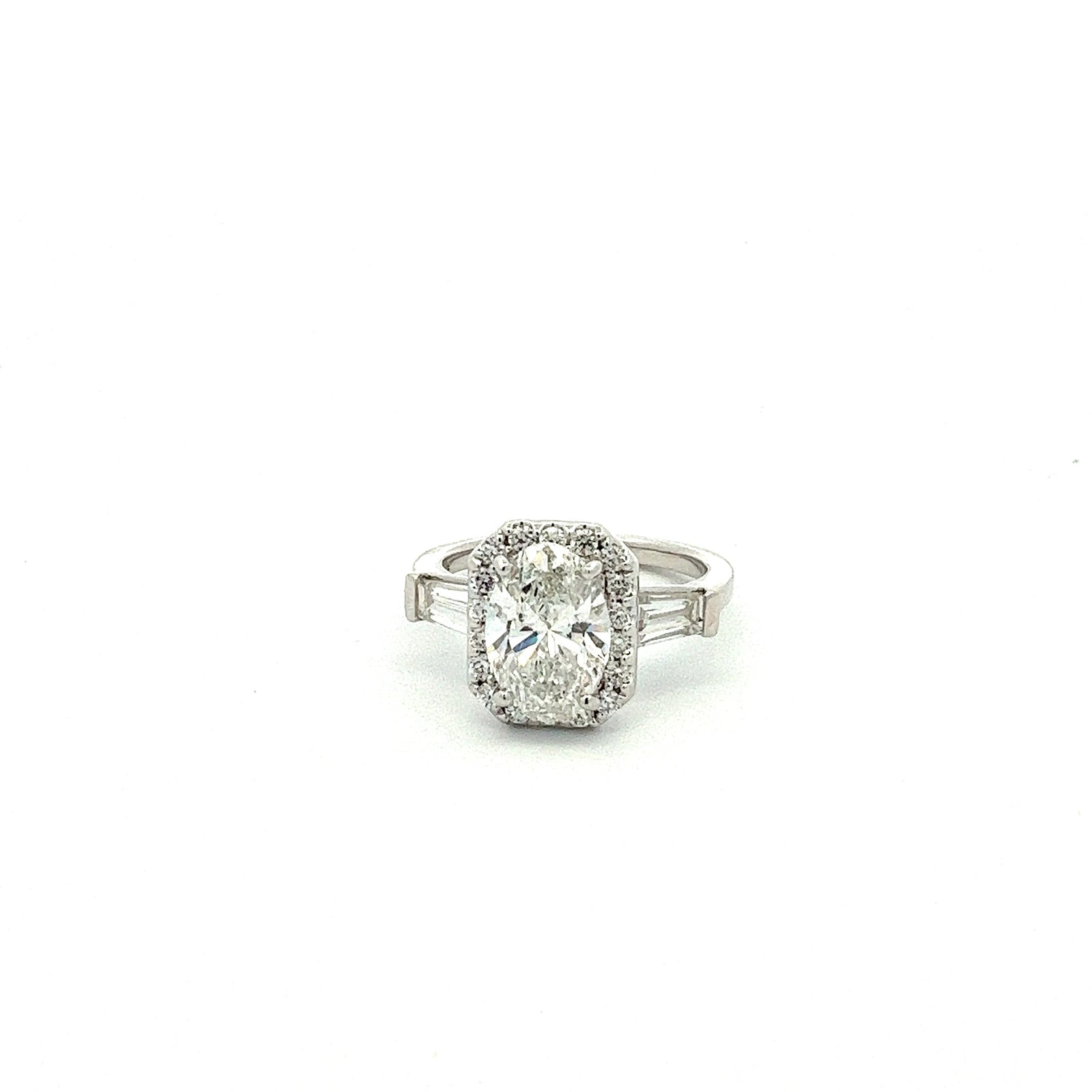 LG OVAL, BAGUETTE, & ROUND DIAMONDS 3.58CTW THREE STONE HALO CENTER RING